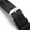 Close-up of a black watch strap with a silver buckle on a white background