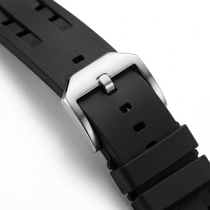 Close-up of a black watch strap with a silver buckle on a white background