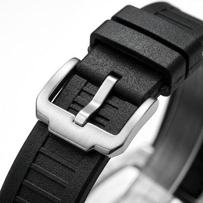 Close-up of a black watch strap with a silver buckle on a white background