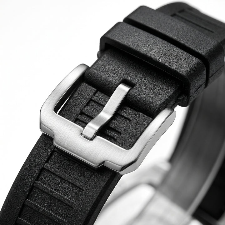 Close-up of a black watch strap with a silver buckle on a white background