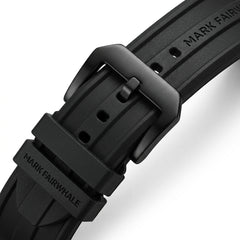 Close-up of a black watch strap with 'Mark Fairwhale' branding on a white background