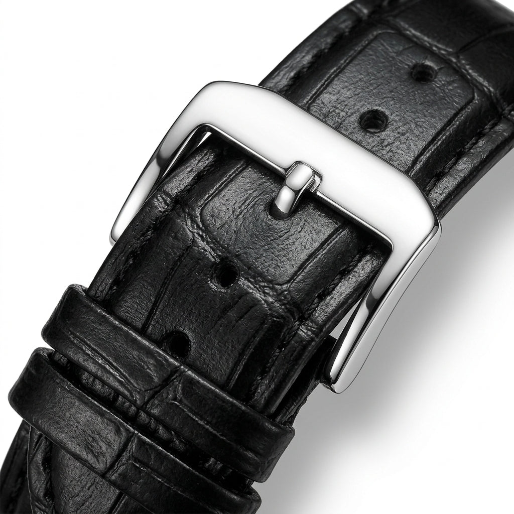 Close-up of a black leather watch strap with a silver buckle on a white background