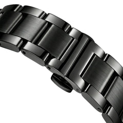Close-up of a metallic watch band on a light gray background