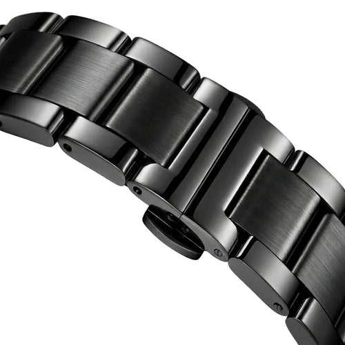 Close-up of a metallic watch band on a light gray background