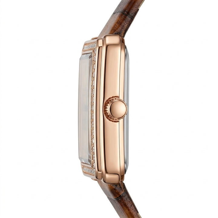 Close-up of a rose gold watch with a brown strap on a white background