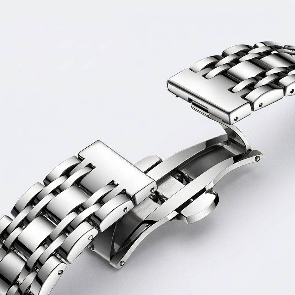 Close-up of a silver metal watch strap on a light gray background