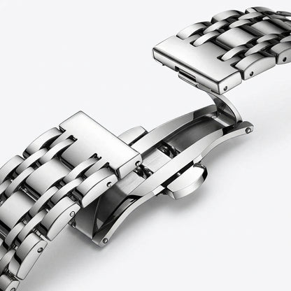Close-up of a silver metal watch strap on a white background