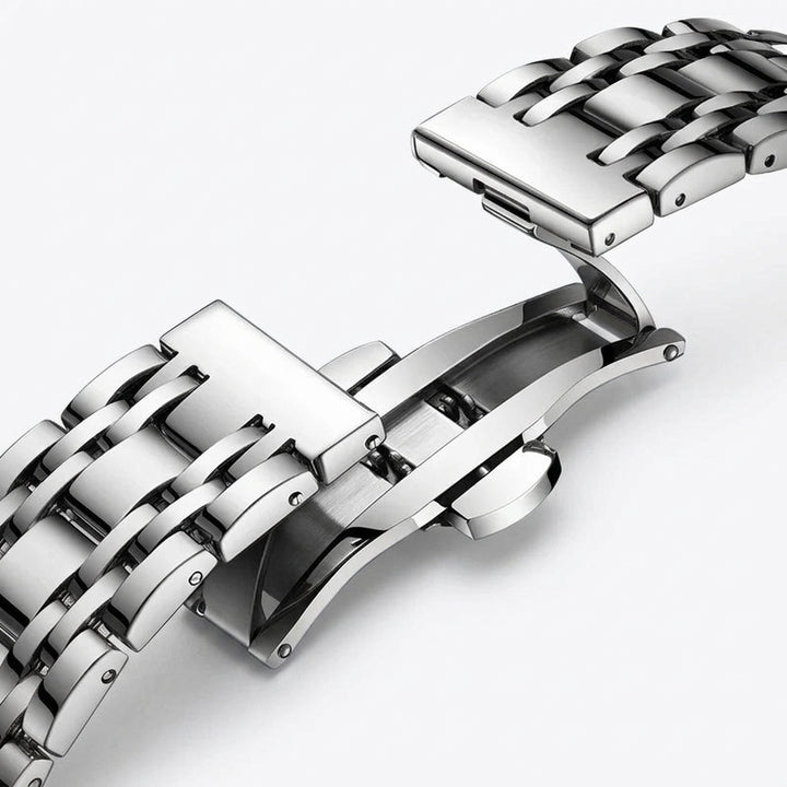 Close-up of a silver metal watch strap on a white background