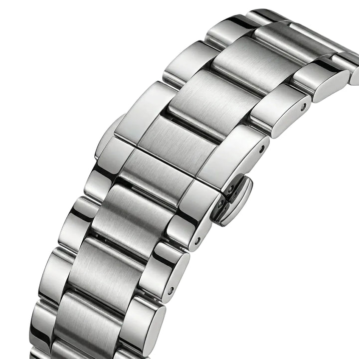 Close-up of a silver metal watch strap on a light gray background