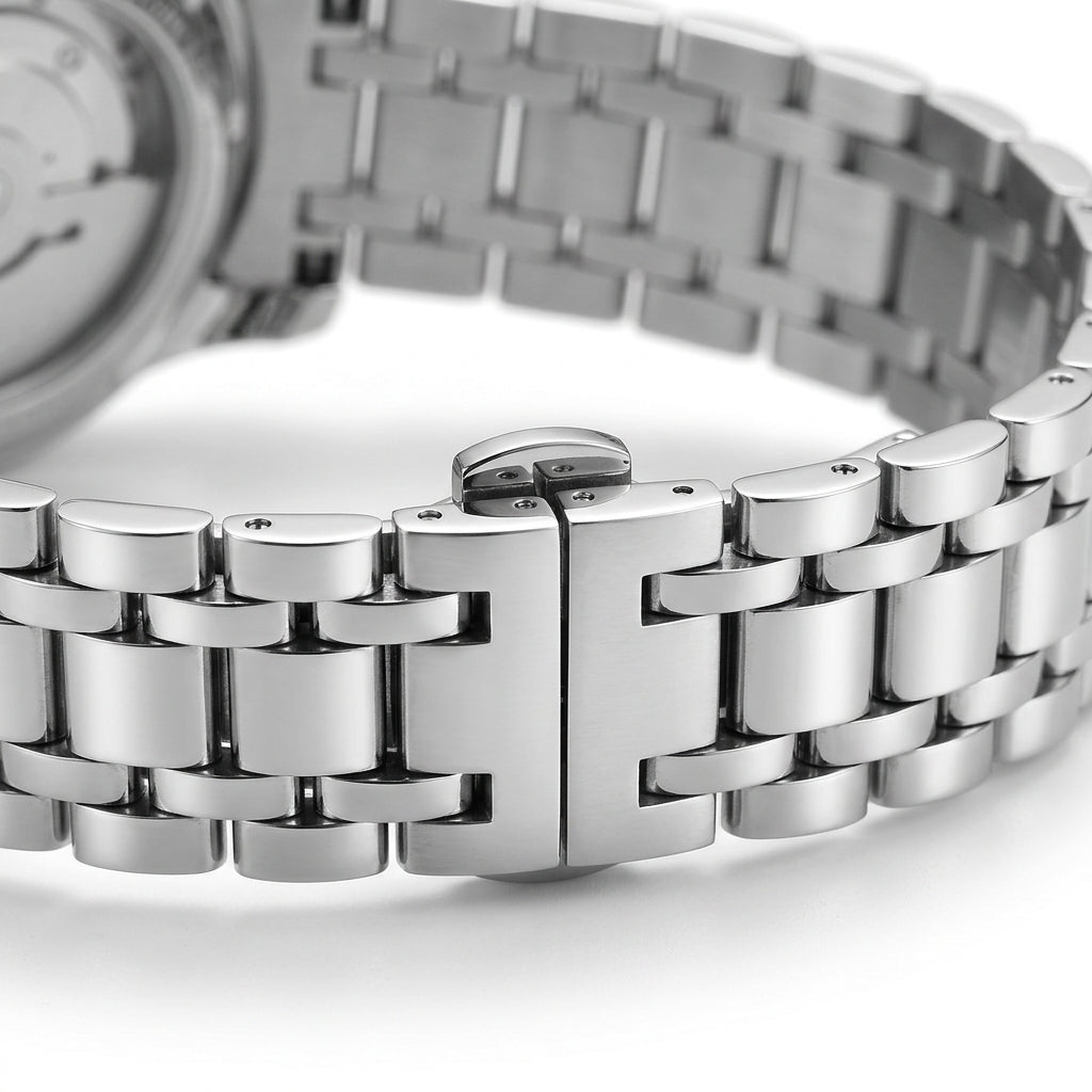 Close-up of a silver metal watch band on a white background