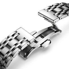 Close-up of a silver metal watch strap on a white background