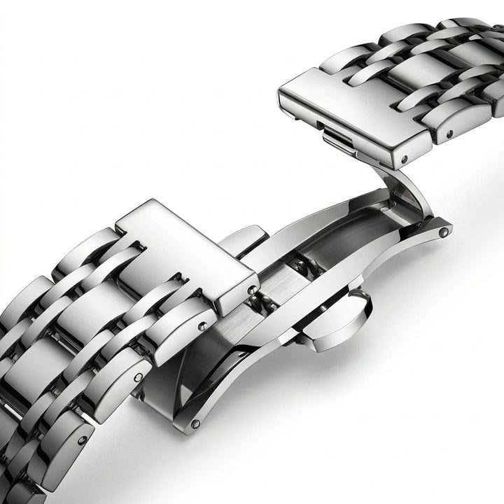 Close-up of a silver metal watch strap on a white background