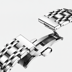 Close-up of a silver metal watch strap on a light gray background