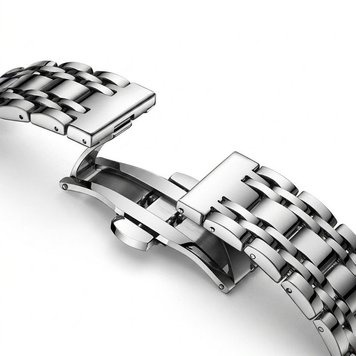 Close-up of a silver metal watch strap on a white background