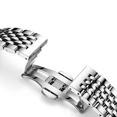 Close-up of a silver metal watch strap on a white background