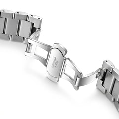 Close-up of a silver metal watch strap on a white background