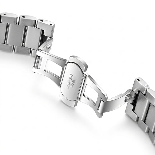 Close-up of a silver metal watch strap on a white background