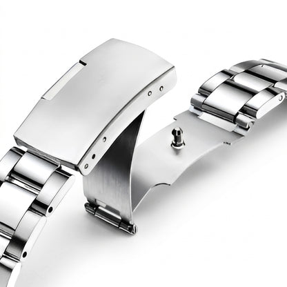 Close-up of a silver watch band on a white background