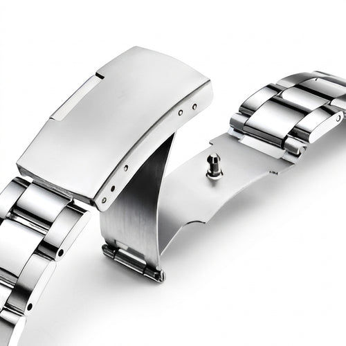 Close-up of a silver watch band on a white background