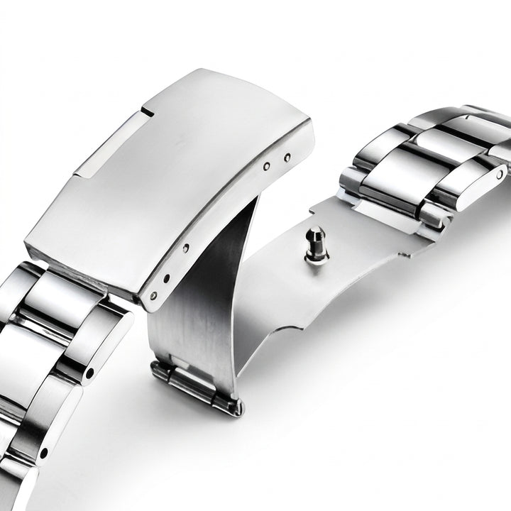 Close-up of a silver watch band on a white background