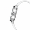 Close-up of a silver watch with a white strap on a white background