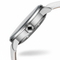 Close-up of a silver watch with a white strap on a white background