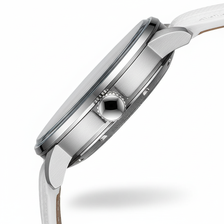 Close-up of a silver watch with a white strap on a white background