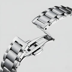 Close-up of a silver watch band on a light gray background