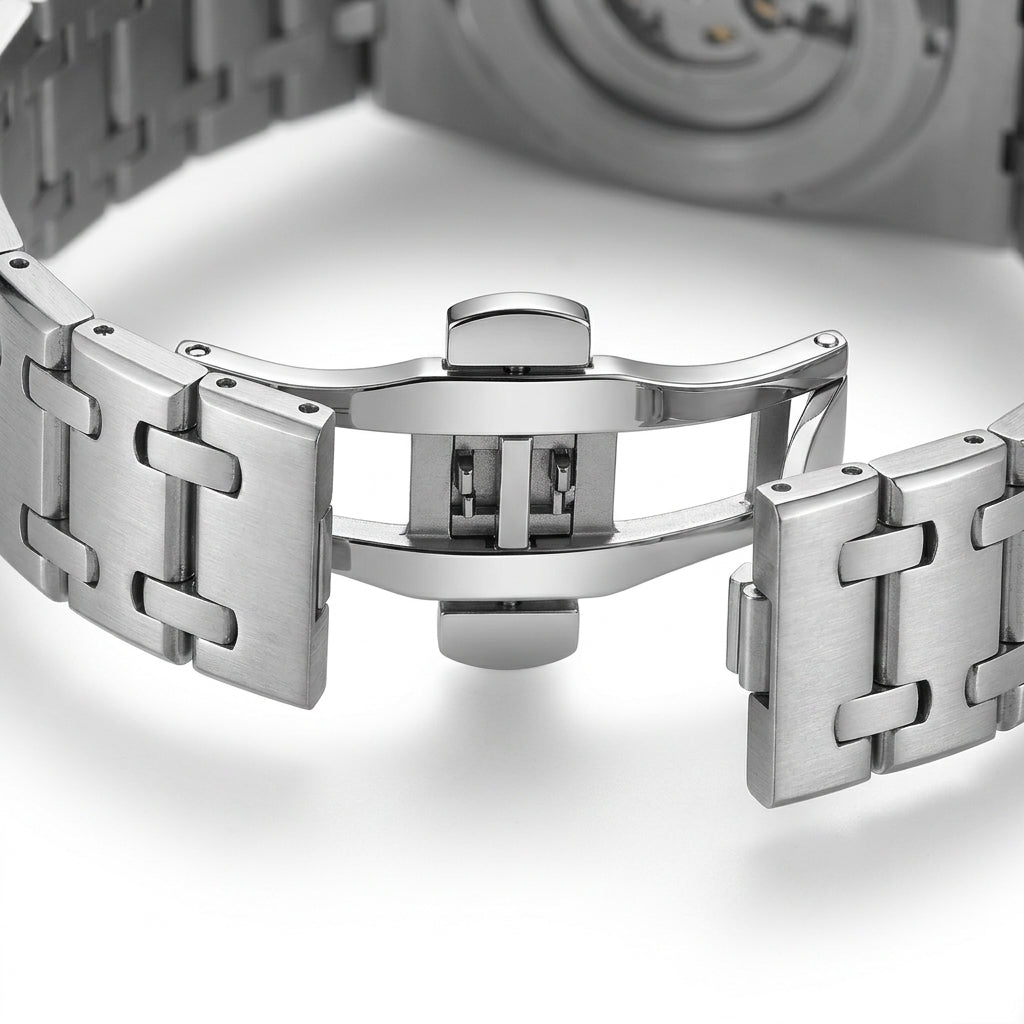 Close-up of a silver watch band on a white background