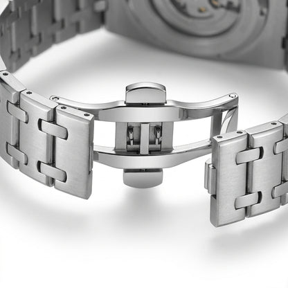Close-up of a silver watch band on a white background