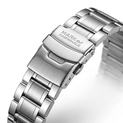 Close-up of a silver watch band with &