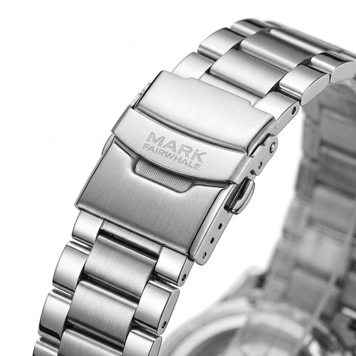Close-up of a silver watch band with &