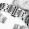 Close-up of a silver watch band with a blurred background