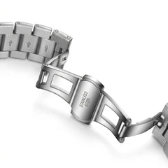 Close-up of a silver watch bracelet with 'Stainless Steel' engraving on a white background