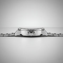 Close-up of a silver watch on a light gray background