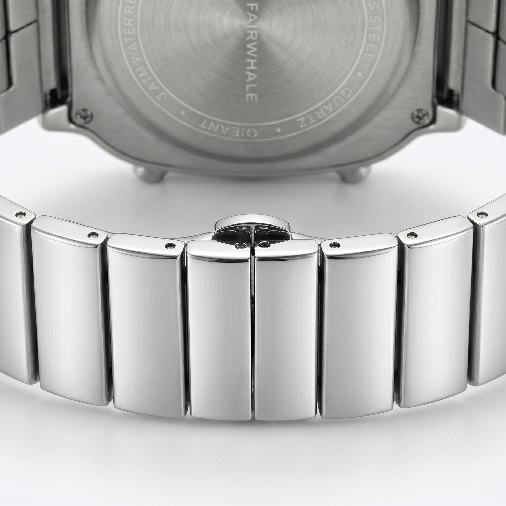 Close-up of a silver watch with a detailed metal band on a white background