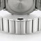 Close-up of a silver watch with a detailed metal band on a white background