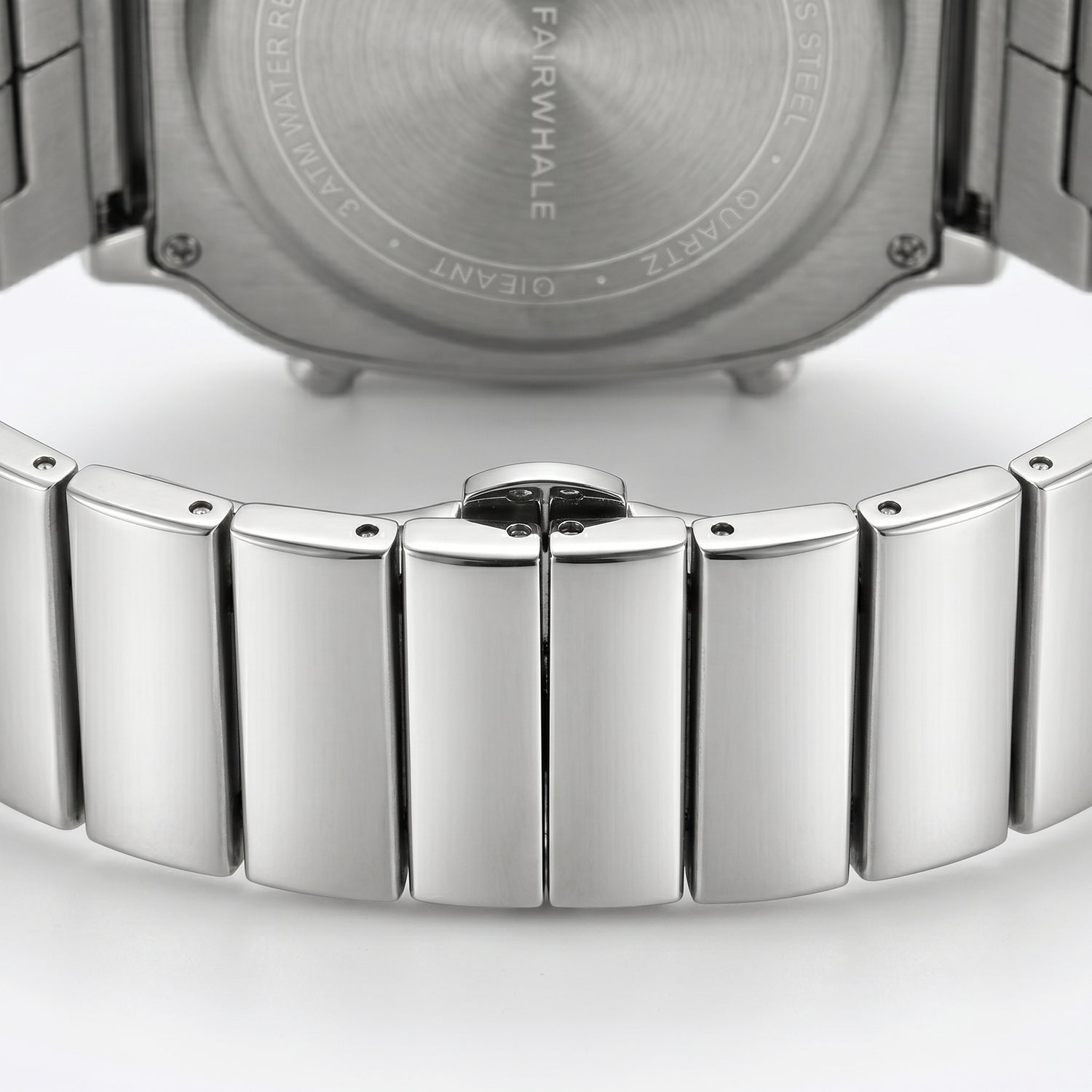 Close-up of a silver watch with a detailed metal band on a white background