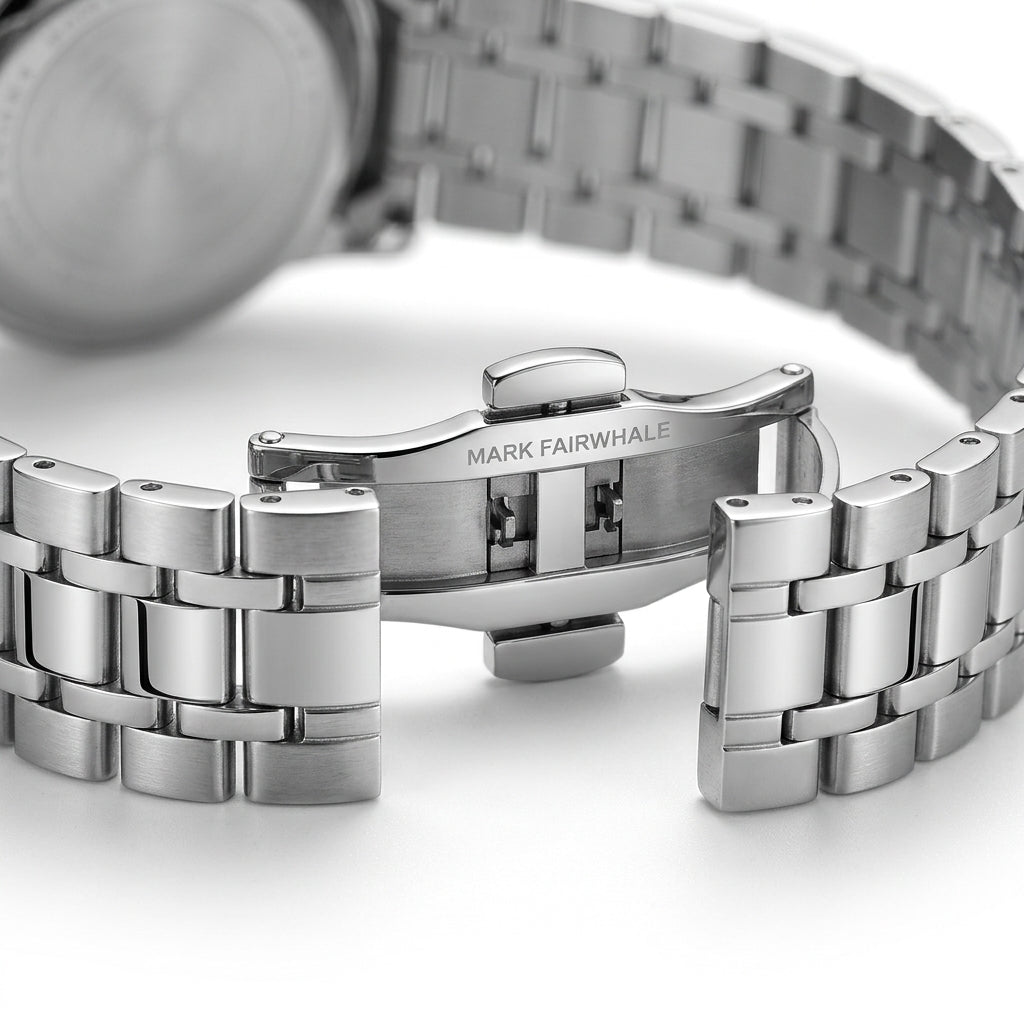 Close-up of a silver watch with a metal bracelet on a white background