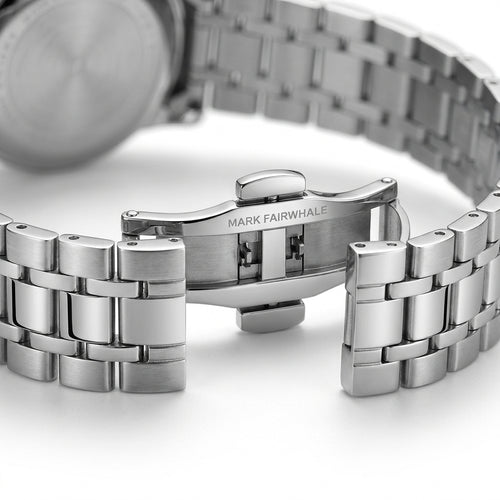 Close-up of a silver watch with a metal bracelet on a white background