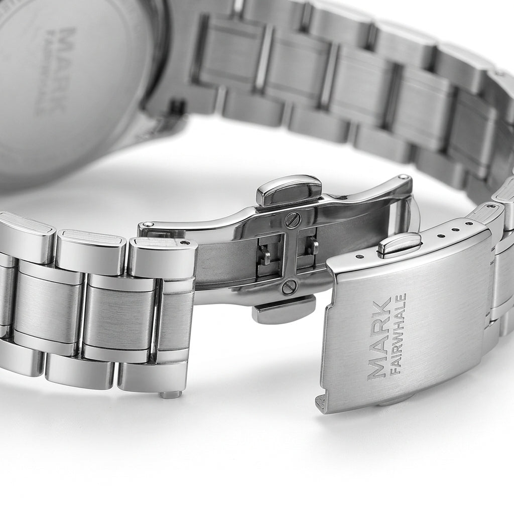 Close-up of a silver watch with a visible brand name on a white background
