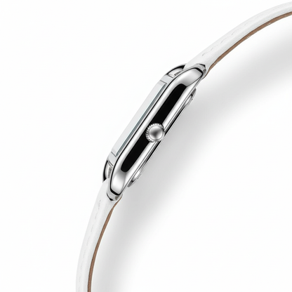 Close-up of a silver watch with a white strap on a white background