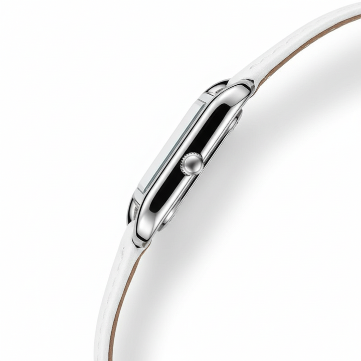 Close-up of a silver watch with a white strap on a white background