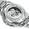 Close-up of a silver watch with visible brand name on a white background