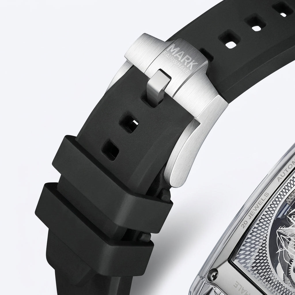 Close-up of a watch with a black strap and silver case on a light gray background
