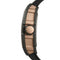 Close-up of a watch with a rose gold and black design on a white background