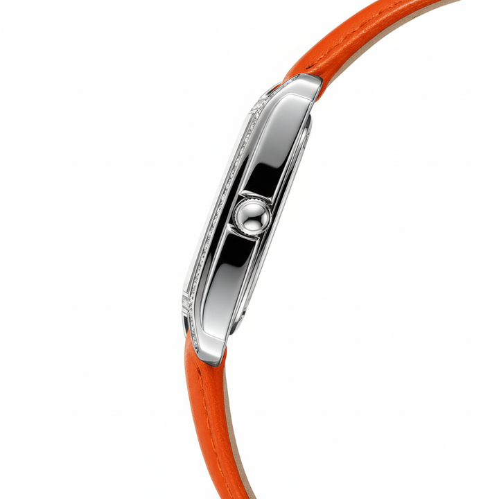 Close-up of a watch with an orange strap and silver case on a white background