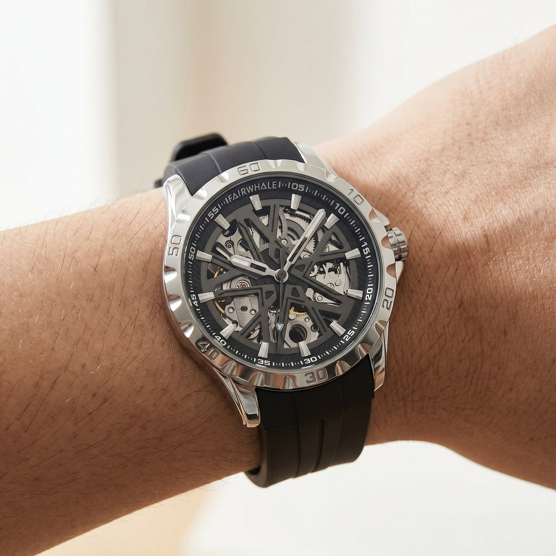Close-up of a wrist wearing a black wristwatch with a detailed face.