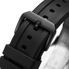 Close-up of a black watch strap with buckle on a white background