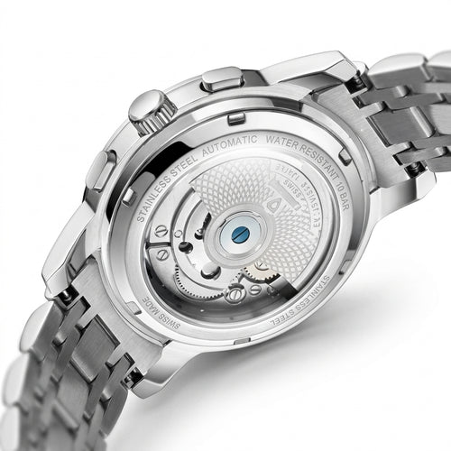 Close-up of the back of a stainless steel wristwatch with a transparent case, showing the automatic mechanical movement and bracelet on a white background.